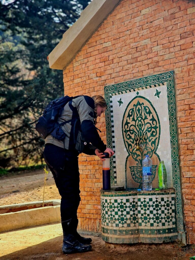 Lauren filtering water from a tap in Morocco.